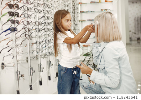 Mother with daughter. People in the store. Child in a white t-shirt. 118243641