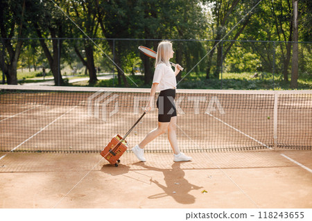 Tennis player going through tennis curt. Model posing. Hobbies, sports, equipment. 118243655