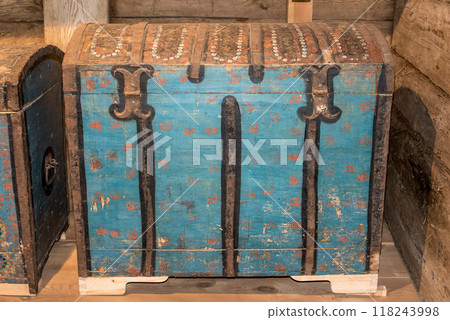 Old wooden chest against wooden wall 118243998