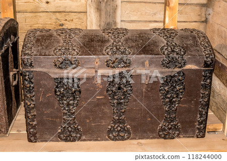 Old wooden chest against wooden wall 118244000