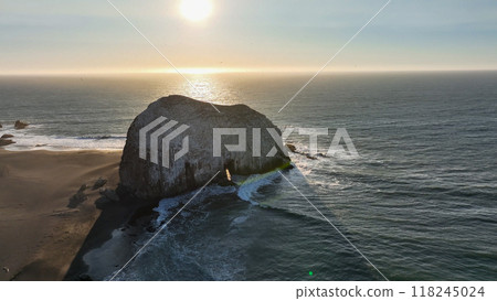 Large rocks natural monument Piedra de Iglecias Church stone on Chilean coast in Constitucion in sunset. 118245024
