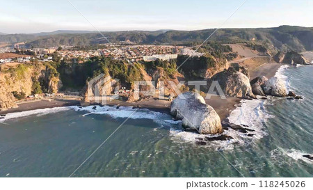 Large rocks natural monument Piedra de Iglecias Church stone on Chilean coast in Constitucion in sunset. 118245026