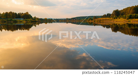 beautiful orange sunset in nature.the forest and the reflection of clouds in the lake beautiful orange sunset in nature.the forest and the reflection of clouds in the lake 118245047