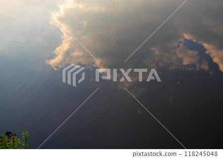 beautiful orange sunset in nature.the forest and the reflection of clouds in the lake 118245048