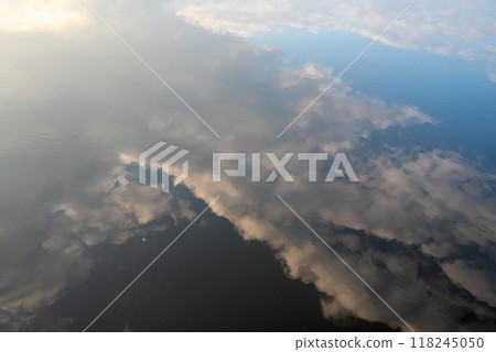 beautiful orange sunset in nature.the forest and the reflection of clouds in the lake 118245050