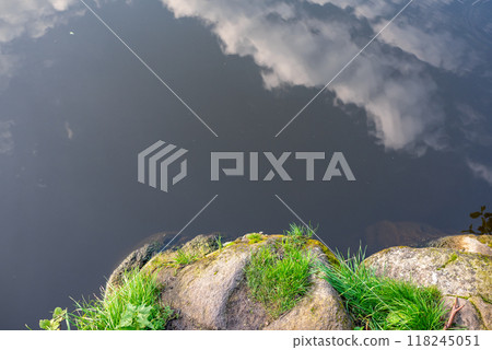 beautiful orange sunset in nature.the forest and the reflection of clouds in the lake 118245051