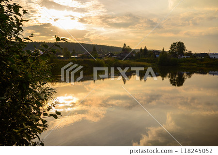 beautiful orange sunset in nature.the forest and the reflection of clouds in the lake 118245052