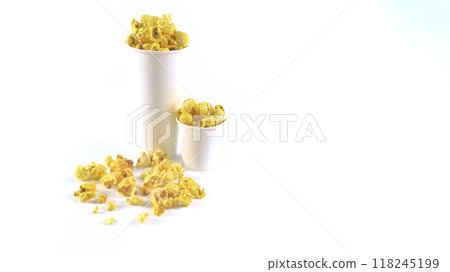 Isolated image of popcorn in a paper cup set against a white background, showcasing the fluffy, golden kernels spilling over the edges, perfect for themes related to snacks, cinema, or casual dining. 118245199