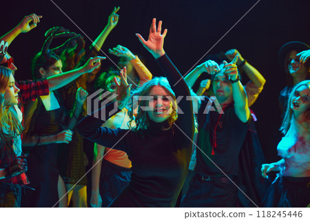 Young people, boys and girls, in diverse Halloween costumes, from ghosts to fairies, dancing at nightclub, celebrating, laughing and having fun 118245446