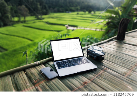 White screen notebook computer on bamboo balcony. Working outside the office concept. 118245709