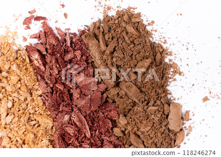 Scattered eye shadows in different shades. Cosmetics texture, white background. 118246274