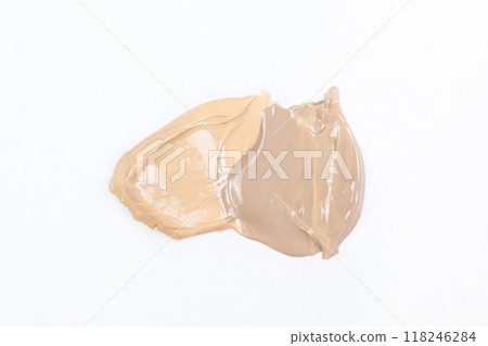 Two strokes of different shades of foundation on a white background. Two strokes of different shades of foundation on a white background. 118246284