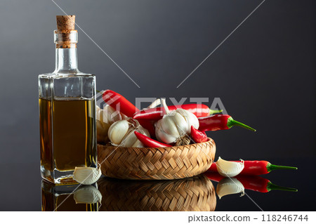 Garlic bulbs, red chili peppers, and bottle of olive oil. Garlic bulbs, red chili peppers, and bottle of olive oil. 118246744