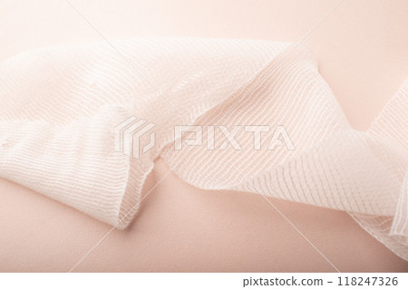 Bandage close up pink background. Bandage texture. Treatment wounds. Applying plaster to the fracture. Medical concept banner. Copy space. High quality photo Bandage close up pink background. Bandage texture. Treatment wounds. Applying plaster to the fracture. Medical concept banner. Copy space. High quality photo 118247326
