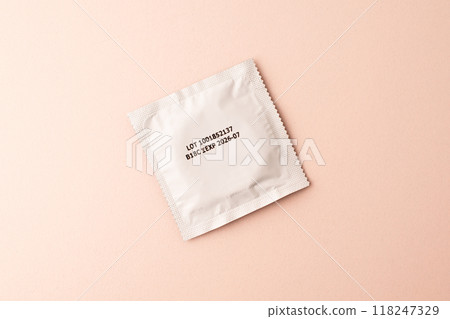 Condom on pink colored background. Mens contraception. Sexually transmitted diseases infections protection. Concept of birth control. Safe sex. STD. View from above. High quality photo Condom on pink colored background. Mens contraception. Sexually transmitted diseases infections protection. Concept of birth control. Safe sex. STD. View from above. High quality photo 118247329