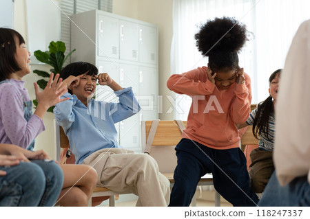 Diverse Group of Children Enjoying a Fun Activity with Teacher in Classroom. Diverse Group of Children Enjoying a Fun Activity with Teacher in Classroom. 118247337