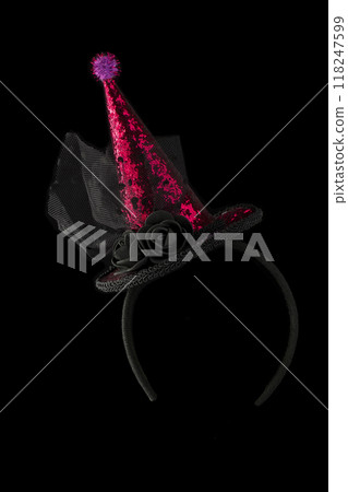 Halloween hat shiny on black background.Bright cap on the hoop. 118247599