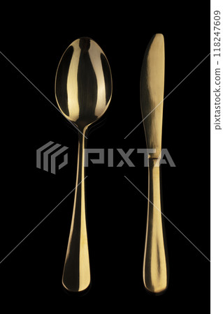 Gold knife and spoon on a black background. Cutlery. Gold knife and spoon on a black background. Cutlery. 118247609