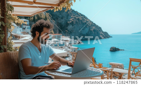 Man Working Remotely on Laptop by the Seaside 118247865