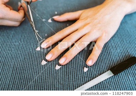 women's hands with manicure, one hand with trimmed nails 118247903