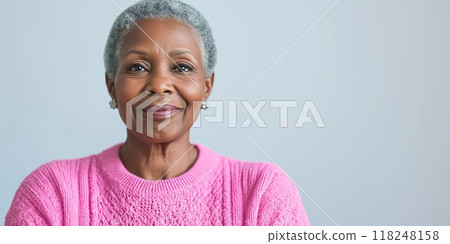 Senior black woman smiling wearing pink for breast cancer awareness 118248158