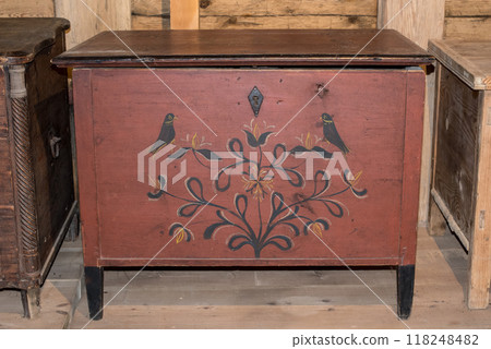 Old wooden chest against wooden wall 118248482