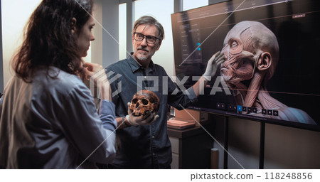 Scientists conduct historical research. Big screen shows 3D visualization of human anatomy 118248856