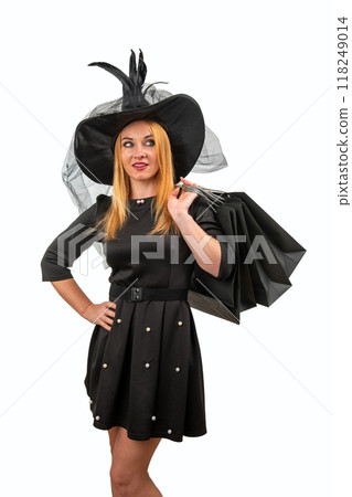 Cheerful witch ready for Halloween, happily shopping in stylish black dress and hat, adding magic to festive season. Get ready for Spooktacular celebration. 118249014