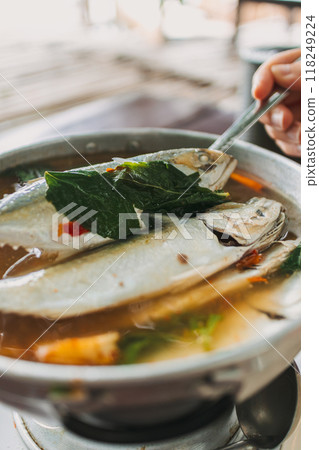 Thai Spicy Mackerel Soup served on wooden table. Thai Spicy Mackerel Soup served on wooden table. 118249224