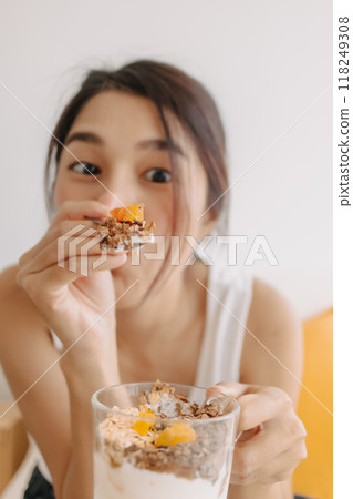 Woman proud to present a cup of homemade yogurt snack for healthy diet. 118249308