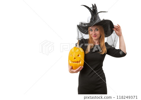 Attractive young woman in witch hat with jack-o-lantern in her hands. White background, space for text. Halloween party Attractive young woman in witch hat with jack-o-lantern in her hands. White background, space for text. Halloween party 118249371