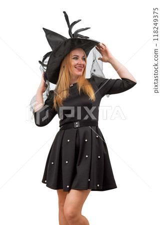 Happy smiling blond woman in black witch hat and black dress. Halloween costume party. White background. Vertical frame 118249375