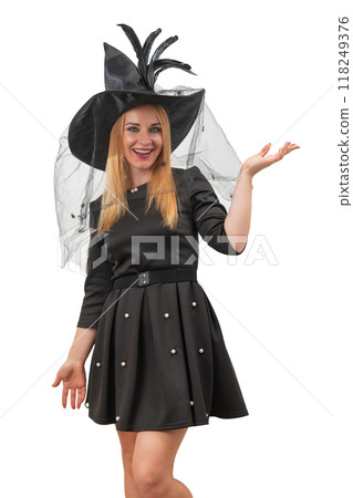 Happy young woman in black witch hat and black dress. Smiling woman. Halloween costume party. White background. Vertical frame 118249376