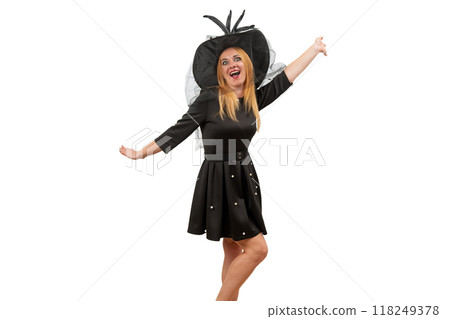 Happy young woman in black witch hat and black dress is dancing. White background. Halloween costume party 118249378
