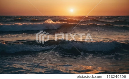 The horizon glows with vivid oranges and reds as waves crash gently against the shore, reflecting the warm colors of the setting sun on the tranquil ocean surface. Generative AI 118249806