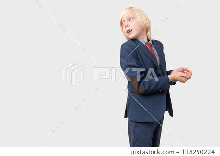 Portrait of a young businessman looking up and thinking over grey background Portrait of a young businessman looking up and thinking over grey background 118250224