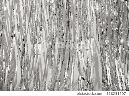 Shiny metallic silver background with crumpled, textured foil pattern. Reflective surface with light 118251307