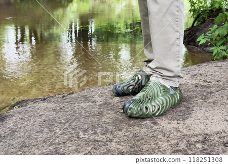 Funny rubber textured shoes on male feet, legs in nature travel, adventure 118251308