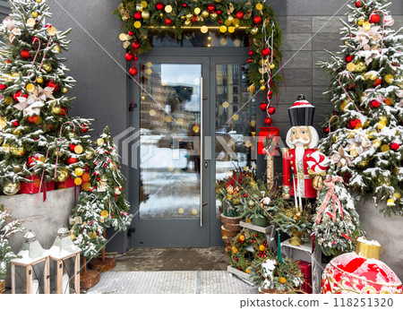 Christmas house entrance decorated with festive garland and ornaments. Winter home exterior with Christmas house entrance decorated with festive garland and ornaments. Winter home exterior with 118251320