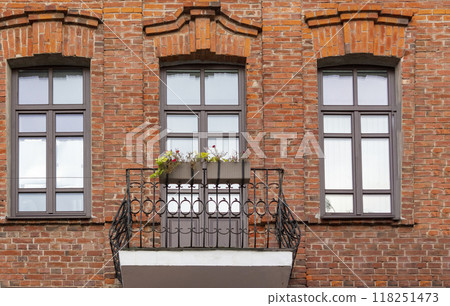 Beautiful flower box on a balcony with green plants and flowers in an old brick house Beautiful flower box on a balcony with green plants and flowers in an old brick house 118251473