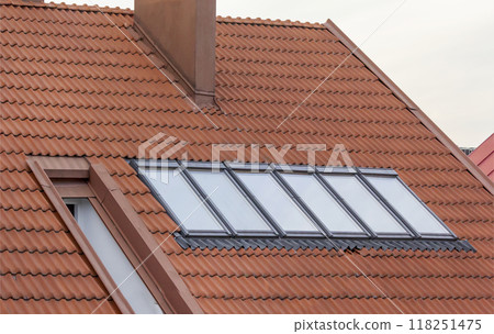 Roofs of houses made of metal red slate. Modern metal roof. Roofs of houses made of metal red slate. Modern metal roof. 118251475