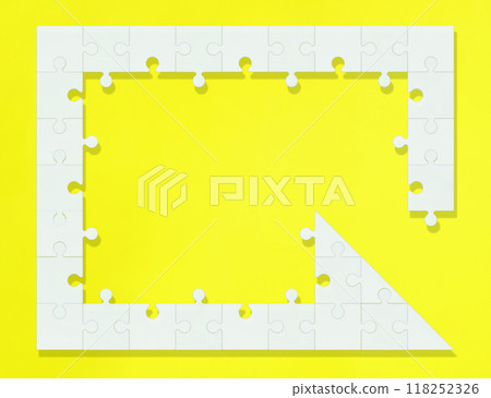A counterclockwise frame of white jigsaw puzzles arranged in the shape of an arrow on a yellow background 118252326