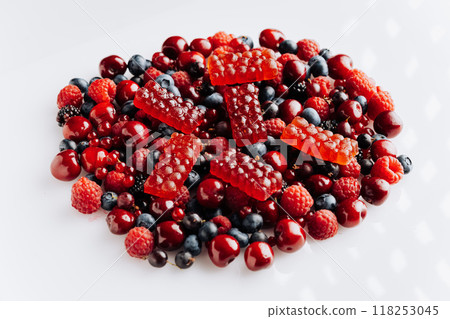 Natural berry marmalade on fresh fruit and berries, perfect for advertising healthy sweet treats Natural berry marmalade on fresh fruit and berries, perfect for advertising healthy sweet treats 118253045