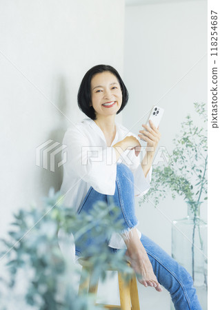 Middle-aged woman in a white shirt Middle-aged woman in a white shirt 118254687