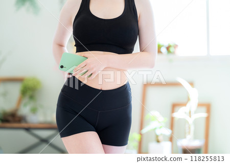 Young woman on a diet in the living room 118255813