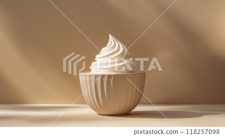 A white bowl with a white swirl of whipped cream on top 118257098