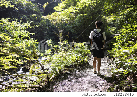 A boy climbing a mountain 118258419