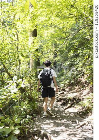 A boy climbing a mountain 118258420