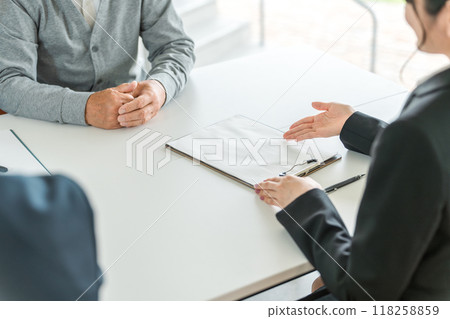 The hands of a female businesswoman in a suit counseling, guiding and introducing a senior man 118258859