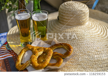 Beer glasses and pretzel on table in Oktoberfest celebration. Beer glasses and pretzel on table in Oktoberfest celebration. 118259153